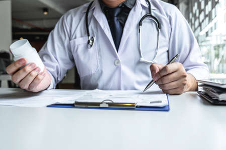 Doctor having conversation with patient while discussing explaining symptoms or counsel diagnosis health and consult treatment of disease, healthcare and assistance concept.の写真素材