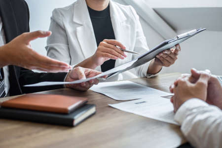 Employer or committee holding reading a resume with talking during about his profile of candidate, employer in suit is conducting a job interview, manager resource employment and recruitment concept.の写真素材