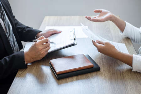 Employer or committee holding reading a resume with talking during job interviewの写真素材