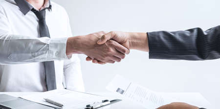 Successful job interview, Boss employer in suit and new employee shaking hands after negotiation and interview, career and placement concept.の写真素材