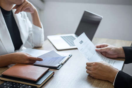 Employer arriving for a job interview, businessman listen to candidate answers explaining about his profile and colloquy dream job, manager sitting in job Interview talking in office.の写真素材