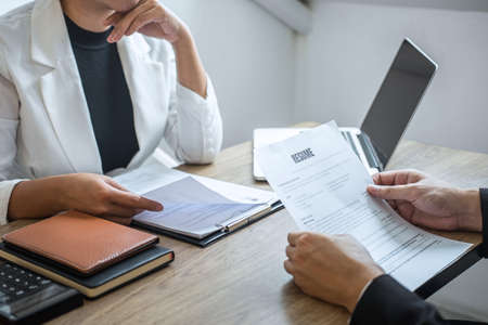 Employer arriving for a job interview, businessman listen to candidate answers explaining about his profile and colloquy dream job, manager sitting in job Interview talking in office.の写真素材