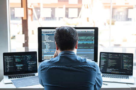Stressed tired out of work, Development Programmer working in programming website a software and coding technology, writing codes and data code, Programming with HTML, PHP and javascript.の写真素材