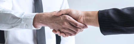 Successful job interview, Boss employer in suit and new employee shaking hands after negotiation and interview, career and placement concept.の写真素材