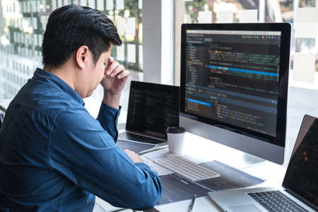 Stressed tired out of work, Development Programmer working in programming website a software and coding technology, writing codes and data code, Programming with HTML, PHP and javascript.の写真素材