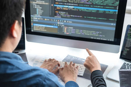 Team of Professional Developer programmer cooperation meeting and brainstorming and programming in website working a software and coding technology, writing codes and database.の写真素材