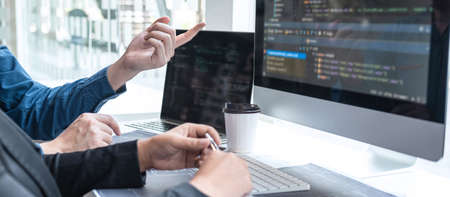 Professional Developer programmer cooperation meeting and brainstorming and programming in website working a software outsourcing and coding technology, writing codes and database.の写真素材