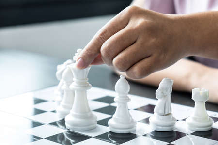 Woman playing chess and thinking strategy plan about crash overthrow the opposite team and development analyze for successful.の写真素材