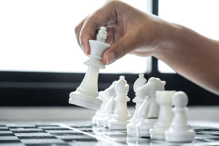 Woman playing chess and thinking strategy plan about crash overthrow the opposite team and development analyze for successful.の写真素材