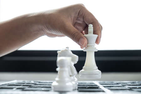 Woman playing chess and thinking strategy plan about crash overthrow the opposite team and development analyze for successful.の写真素材