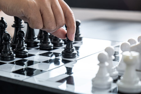 Woman playing chess and thinking strategy plan about crash overthrow the opposite team and development analyze for successful.の写真素材