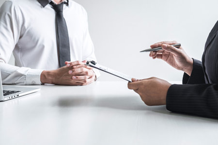 Employer arriving for a job interview, committee listen to candidate answers explaining about his profile and colloquy dream job, manager sitting in job Interview talking in office.の写真素材