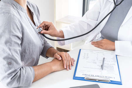 Doctor using a stethoscope checking patient with examining, presenting results symptom and recommend treatment method, Healthcare and medical concept.の写真素材