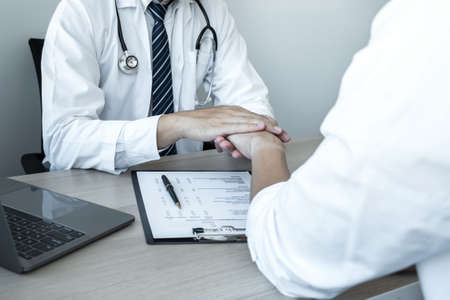 Image of doctor holding patient's hand to encourage, talking with patient cheering and support, healthcare and medical assistant.の写真素材