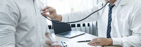 Doctor using a stethoscope checking patient with examining, presenting results symptom and recommend treatment method.の写真素材