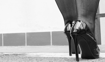 Sexy legs in black high heels and fishnet stockingsの写真素材