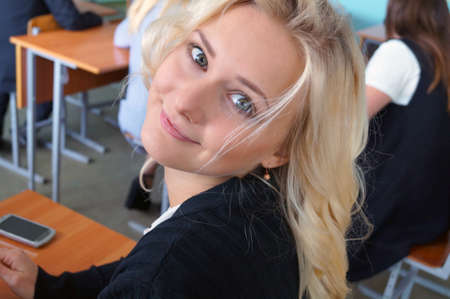 The girl in the classroom gets an education, a turn with a tilt of the headの写真素材