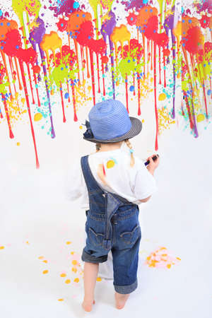Child playing with paintの写真素材