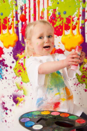 Child playing with paintの写真素材