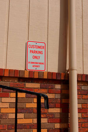 Customer parking sign at back door of business.の写真素材