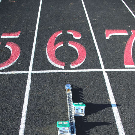 Starting blocks in lane six of a black track.