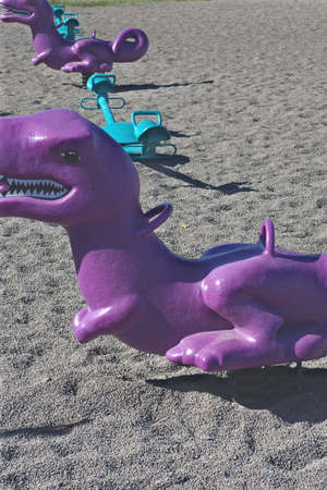 Row of purple and blue toys at the playground.の写真素材