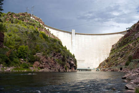 A large, electricity producing dam on a river.の写真素材