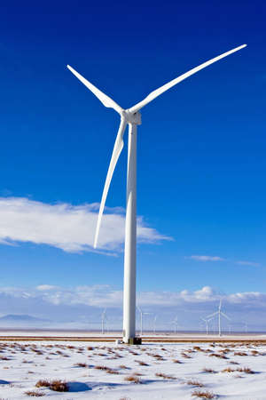 New wind turbines produce energy at a high desert wind farm.