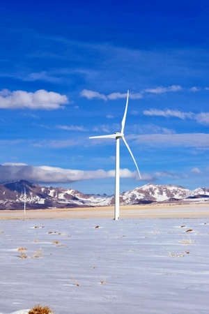 A lone wind turbine stands in a high desert environment.の写真素材