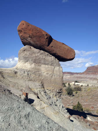 A red sandstone block atop a white sandstone pedestal.の写真素材