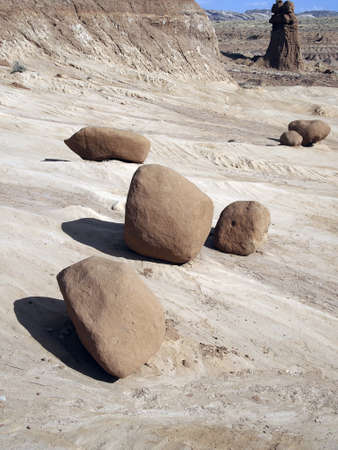 A collection of red sandstone boulders in a desert area の写真素材