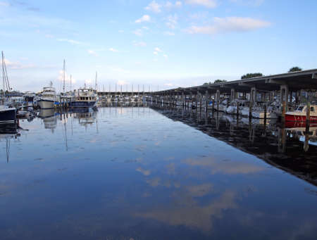 Boats at rest in a placid harbor.の写真素材