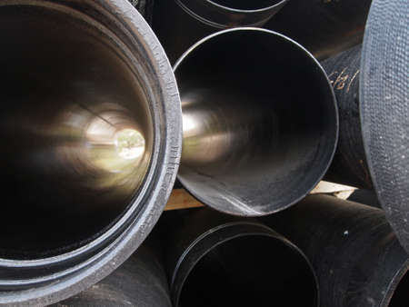 A stack of steel pipes at a construction site.