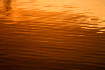 The beautiful colours of sunset reflected in the wavesの写真素材
