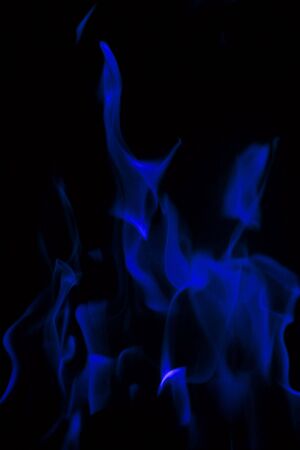 Blue flowing flames on a black backgroundの写真素材