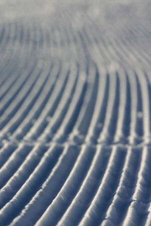 Tracks on a fresh skislope, close-up of the snow.の写真素材