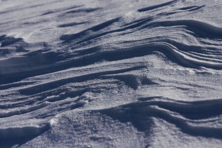 Close-up of snow, melted by the sun and frozen again. Interesting website background!の写真素材
