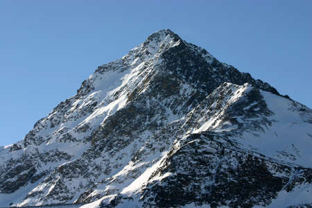 A single snowy peak, mountain in winter landscapeの写真素材