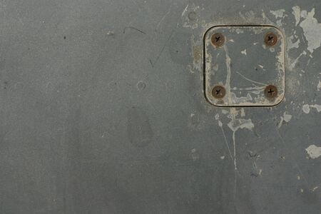 Four rusty screws on an iron plateの写真素材