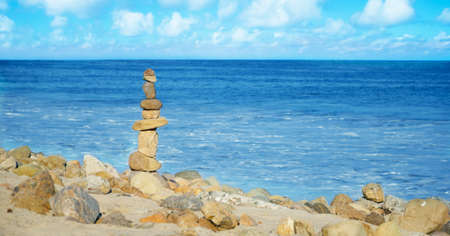 Stack of sea rocks balancing by Pacific ocean 