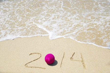 Number 2014 with christmas decoration on the sandy beach - holiday conceptの写真素材