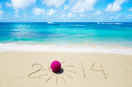 Number 2014 with christmas decoration on the sandy beachの写真素材