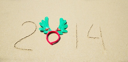 Number 2014 with christmas decoration on the sandy beachの写真素材