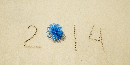 Number 2014 with christmas decoration on the sandy beachの写真素材