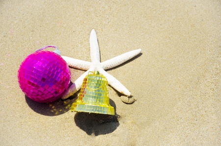 Number 2014 with starfish and christmas decoration on the sandy beach
