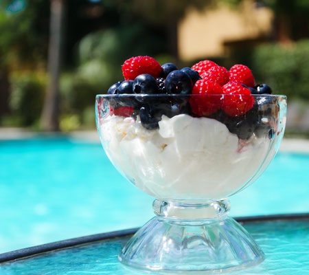 Morning dessert with fresh berries by the swimming poolの写真素材