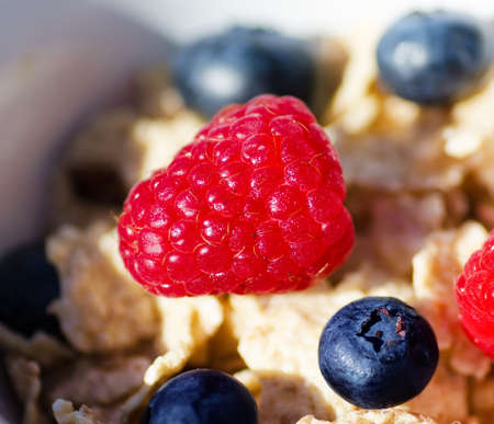 Healthy breakfast with cereals, blueberry, raspberry. Selective focus.の写真素材