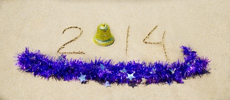 Number 2014 with christmas decorations on the sandy beach - holiday conceptの写真素材