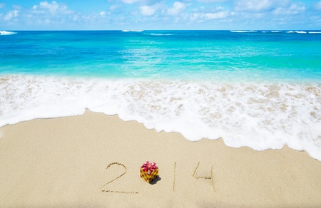Number 2014 with christmas decoration on the sandy beach - holiday conceptの写真素材