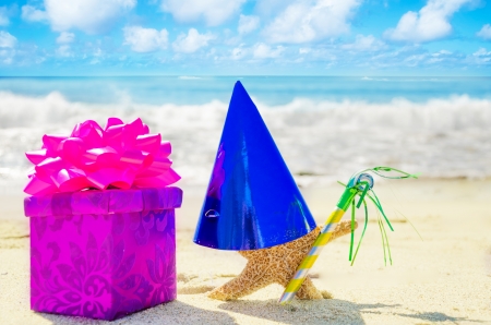 Birthday decorations on the sandy beach by the oceanの写真素材